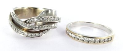 two wedding rings with diamonds on them on a white surface