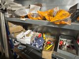 a metal shelf filled with assorted items in a kitchen