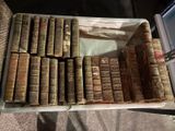 beaucoup de vieux livres dans une boîte posée sur une table