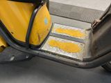 a yellow scooter parked on the side of the street