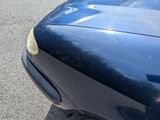 a close up of a black car with a yellow sticker on it ' s hood