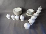 a lot of white dishes and cups on the table