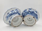 pair of blue and white vases on a white background