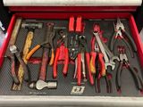 many tools in a tool box on the floor