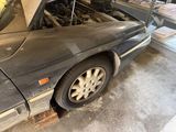 a car that is parked in a garage with its hood open