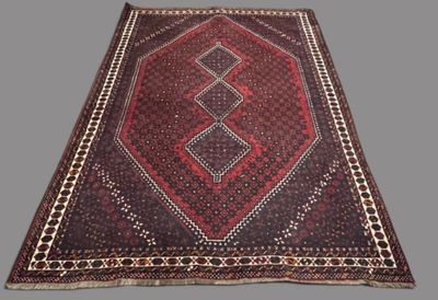 an oriental rug with a geometric design on a grey background