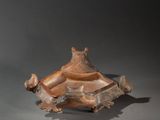 an image of a wooden sculpture of a man sitting on top of a box