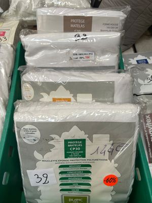 many bags of toilet paper sitting in a green bin