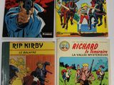 quatre bandes dessinées posées sur une table avec un fond blanc