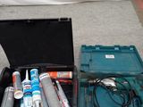 two tools in a case on the floor next to each other
