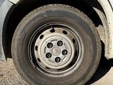 a white van with a sticker on the side of it ' s tire