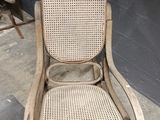 a wooden rocking chair with a wicker seat on it