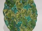 a green plate with a lot of green leaves on it