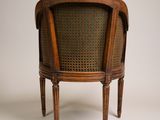 an old wooden chair with wicker back and arms and legs