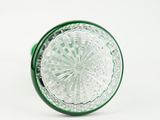 green glass knob with a circular design on a white background