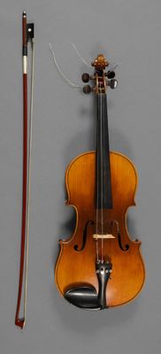 a violin that is sitting next to a bow