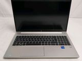an open laptop computer sitting on top of a white table