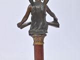 statue of a woman with wings on a pedestal on a white background