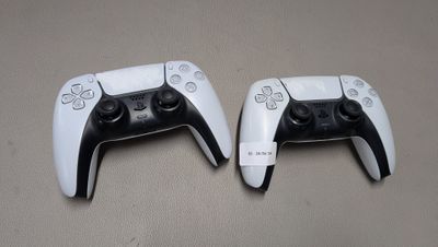 deux manettes de jeux vidéo posées l'une à côté de l'autre sur une table