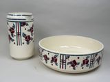 two bowls and a cup sitting next to each other on a table