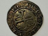 a close up of a coin with a cross on it