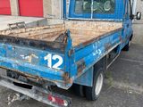 a blue truck that is parked in front of a building