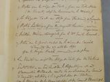 an old document with writing on it sitting on top of a table