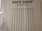 a box of safe snap safety gate sitting on the floor