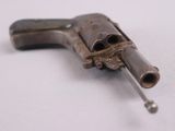 an old gun that is on a white surface