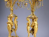 pair of antique brass candelabs with figurines on stands