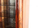 a wooden cabinet with a glass door on the top