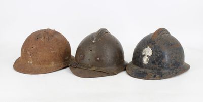 three helmets are lined up in a row on a white surface