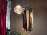 a dining room with a table, chairs, and a mirror