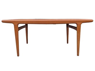 the table is made of teak and has a curved top