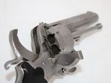 a gun that is sitting on a white surface