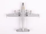 a model of a silver airplane on a white surface