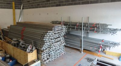 a large pile of steel bars in a warehouse