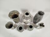 several different types of metal pipes and fittings on a white surface