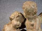 a statue of two little angels sitting next to each other