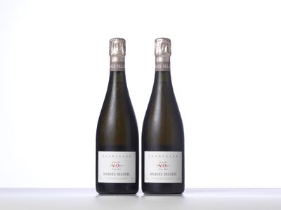 two bottles of wine sitting next to each other on a table
