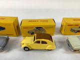 three toy cars are sitting next to each other on a white surface