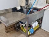 a kitchen with a stainless steel sink and a washing machine