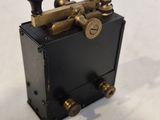 a small black box with brass fittings on it