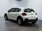 the rear of a white car is parked in a white room
