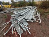 a pile of metal bars on the ground next to a train