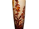 un vase orné d'un motif floral sur une surface blanche