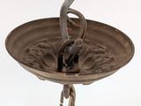 a bird that is sitting on top of a metal plate