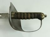 a close up of a sword on a white surface