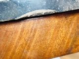 a close up of a piece of wood with a knife on it