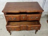 an old wooden dresser with three drawers and a drawer underneath it